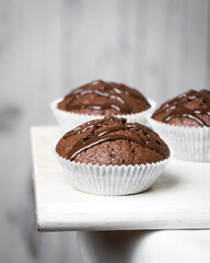 Little chocolate muffins in white background