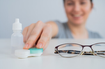 Caucasian woman prefers contact lenses to glasses. 