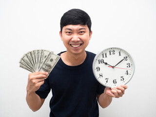 Portrait man holding a lot of money with analog clock in hand happiness smile