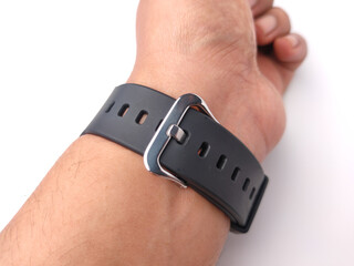 Buckles and black rubber straps watch on someone hand are isolated on a white background.