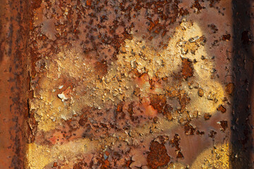 rusty and cracked metal textured background with golden paint