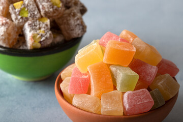 Traditional Turkish delight and pistachio candy in two bowls
