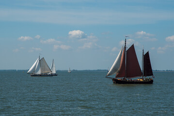 Naklejka premium Oosterleek, Netherlands, May 2022. Old traditional sailing ships on the Markermeer, Netherlands.
