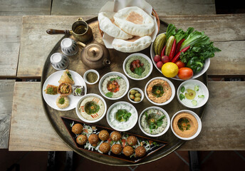 mixed middle eastern meze sharing food platter in turkish restaurant - obrazy, fototapety, plakaty