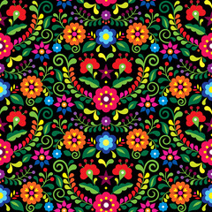Fototapeta na wymiar Mexican folk art vector seamless pattern with flowers, textile or fabric print design inspired by traditional embroidery ornaments from Mexico on black 
