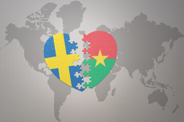 puzzle heart with the national flag of sweden and burkina faso on a world map background. Concept.