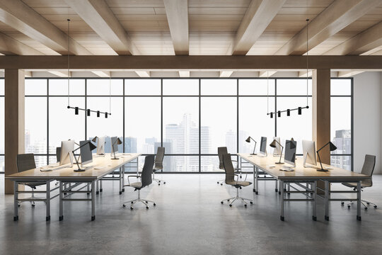 Front view on stylish workspace rows with modern computers on concrete floor in spacious coworking office with wooden ceiling and city view from huge window. 3D rendering