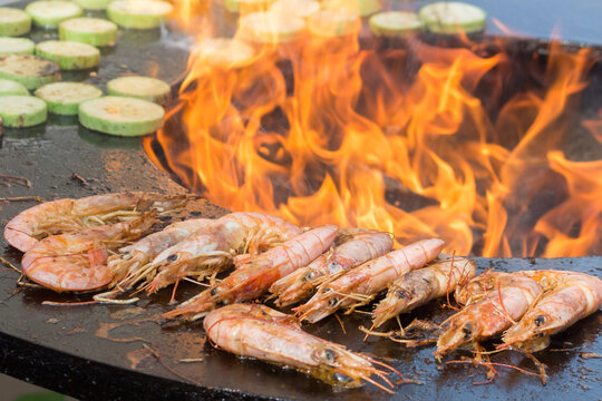 The process of cooking shrimp on a brazier. Open fire. Close-up.