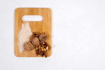 Alternative walnuts flour. Grated crushed walnuts, white background. Copy space