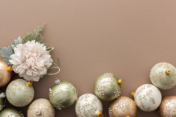Christmas balls and decorative flowers on powdery background, Merry Christmas and Happy New Year concept, top view, copy space