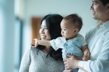 young Asian family are happy together at home by life insurance concept, child baby and mother and...