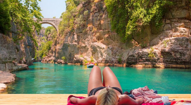 Woman sunbathing at Koprulu canyon, Koprucay river - Antalya, Turkey 