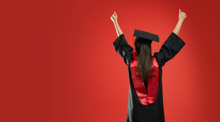Back view of brunette girl with long hair standing back, showing hurray. Young female graduating...