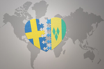 puzzle heart with the national flag of sweden and saint vincent and the grenadines on a world map...