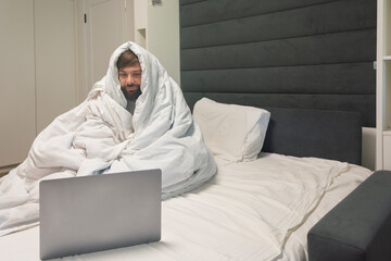 Remote work freelancing from home while sick in a white bed mockup copy space