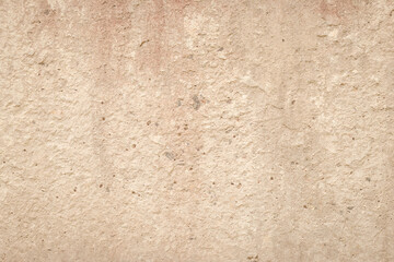 Beige cement wall, abstract light background. Concrete grunge texture, stucco. Plaster surface. Blank space. Design backdrop. Natural grungy wallpaper.