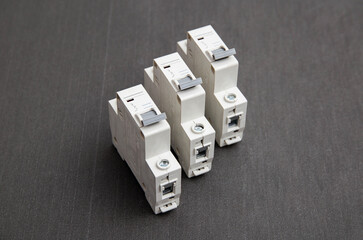 Electrical circuit breakers on a gray background, close-up. Designed for switching electrical circuits and their protection.