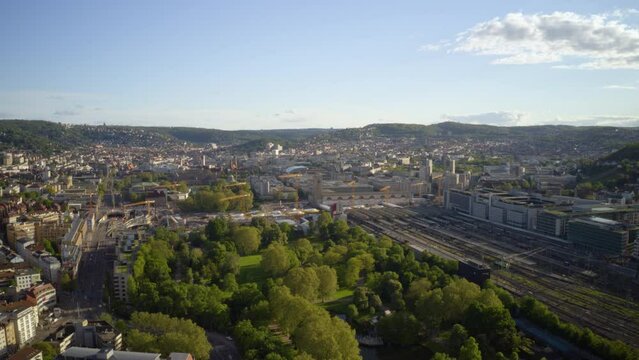 Time lapse drone POV sunny cityscape and railyard, Stuttgart, Germany
