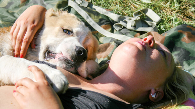 The girl is lying with the dog. Central Asian Shepherd Dog, Alabay or Alabai