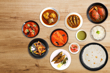 Assorted Indian seafood dishes. Bangda Fry, Crabs, Prawns and pomfret curry, Tandlachi Bhakri, Rice, and gulab jamun. along with green chutney and salad. Copy space. Malwani fish thali. Maharashtrian 