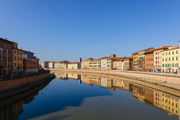 Fototapeta na wymiar Bridge over river in Pisa. Italy. Sunny day