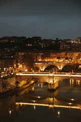Fototapeta na wymiar Bridges over Tiber river in Rome at night