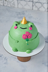 Cake in the shape of a frog with flowers. Children's birthday cake.