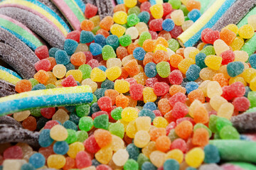 Candy sweets jelly. Close up view of delicious multicolor sweet candies in form of sticks, berries. Fruit jelly in shop window. Sweets for Easter, Halloween. Unhealthy or organic food. Selective focus