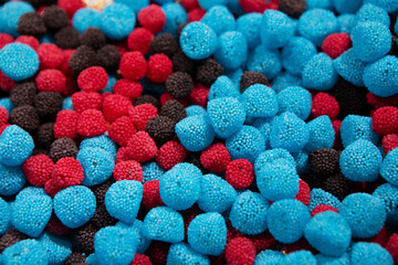 Candy sweets jelly. Close up view of delicious sweet candies in form of berries. Fruit jelly in shop window. Sweets for Easter, Halloween. Unhealthy or organic food. Selective focus 