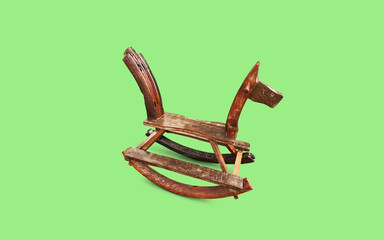 wooden rocking horse on green background