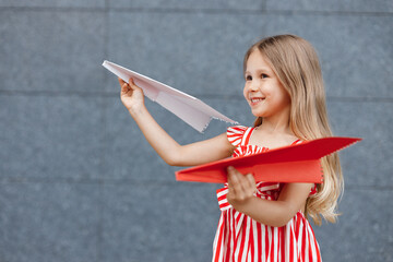 little cute girl with paper airplane outdoor