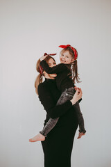 Pregnant mother with her preschool daughter having fun in matching outfits 