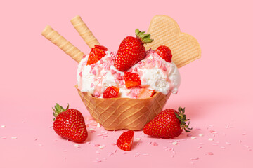 cone with scoops of ice cream strewed sprinkles, poured with glaze and decorated strawberries on...