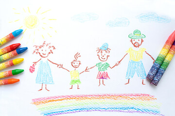 Child's drawing of happy family with colored pencils crayons. Family of mom, dad and two children....