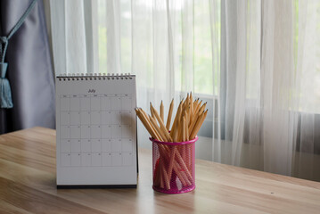 2022 Calendar desk place on table. Desktop Calender for Planner to plan agenda, timetable, appointment, organization, management each date, month, and year on wooden office table. Calendar Concept.