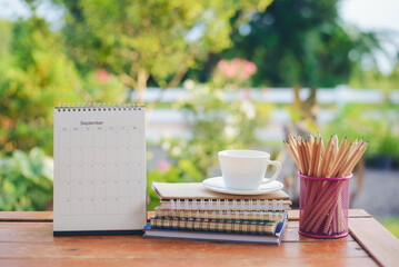 Diary and Planner Book on School table for Student, study for exam. Wooden desk with laptop, tablet, notebook, and pencil. Desk for student work at home concept.