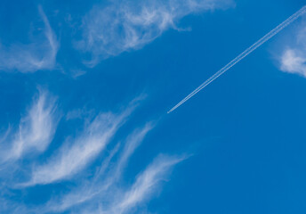 track from aircraft in the blue sky with white clouds in sunny day