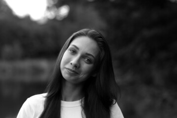 Outside portrait of beautiful long-haired woman in black and white