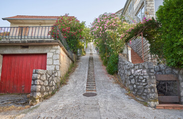 Narrow street in residential district with uphill, Montenegro