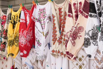 Ethnic ukrainian traditional embroidered shirts, vyshyvanka as background - traditional embroidered clothing on flea market or national festival. Symbol of Ukrainian culture