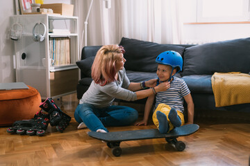 mother and son preparing for driving skateboard and rollerblade