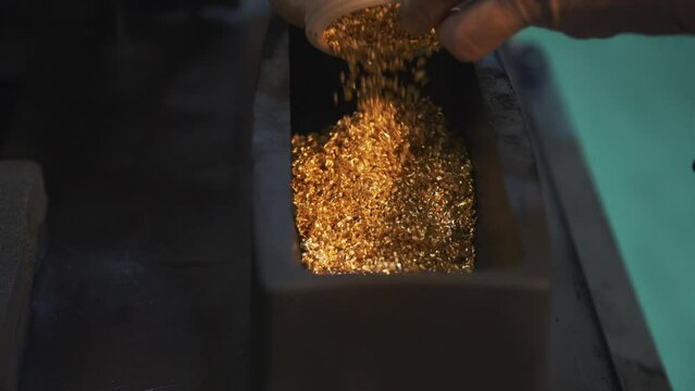 This stock video shows the process of making gold bars from precious metal granules. This video will decorate your projects.