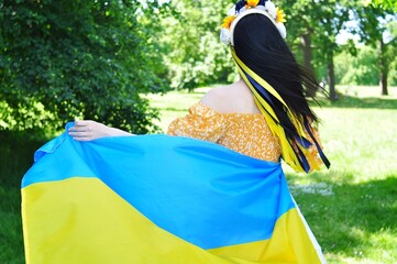 Woman with Ukrainian yellow and blue national flag of Ukraine 