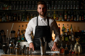beautiful view on bar counter with bar equipment and steel tools and bartender