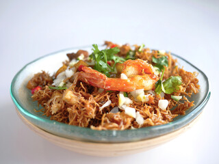 Thai Crispy rice noodles in traditional style with shrimp, Royal recipe, in special plate with copy space and white background