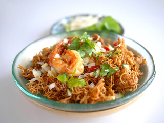 Thai Crispy rice noodles in traditional style with shrimp, Royal recipe, in special plate with vegetable, copy space and white background