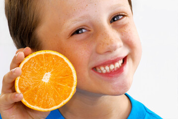 Happy kid holding an sliced orange fruit portrait.