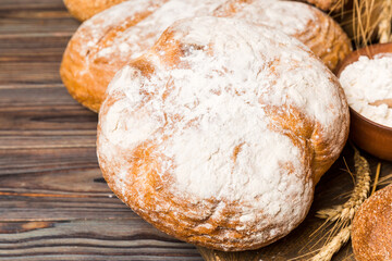 Homemade natural breads. Different kinds of fresh bread as background, perspective view with copy space