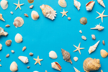 Summer time concept Flat lay composition with beautiful starfish and sea shells on colored table, top view