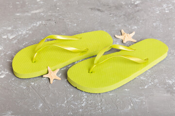 Beach accessories. Flip flops and starfish on colored background. Top view Mock up with copy space